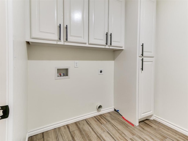 26603 Main St, Blanchard, OK 73010 - laundry room with electric dryer hookup, light wood-style floors, washer hookup, baseboards, and cabinet space