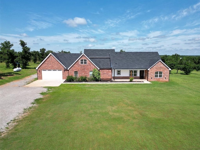 26603 Main St, Blanchard, OK 73010 - view of front of house featuring gravel driveway, brick siding, a garage, a front yard, and roof with shingles