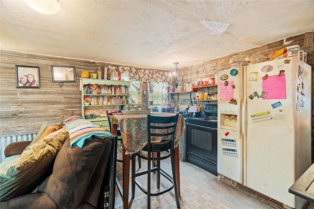 21380 E Fifth St, Hinton, OK 73047 - kitchen with black / electric stove, white refrigerator with ice dispenser, wooden walls, and a textured ceiling