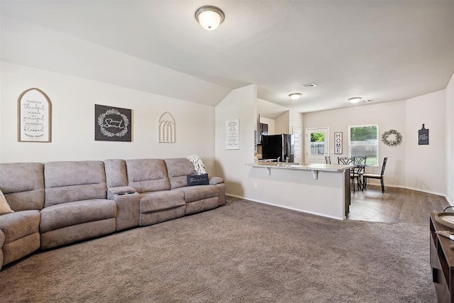 11604 NW 95th St, Yukon, OK 73099 - carpeted living area featuring baseboards and lofted ceiling