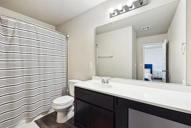 11604 NW 95th St, Yukon, OK 73099 - bathroom with vanity, connected bathroom, wood finished floors, and a shower with curtain