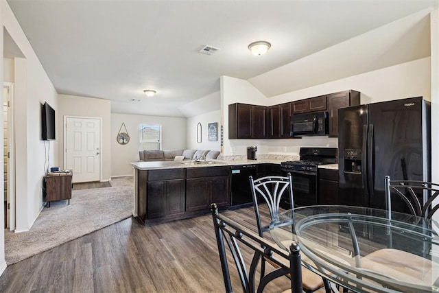 11604 NW 95th St, Yukon, OK 73099 - kitchen with black appliances, open floor plan, dark brown cabinets, wood finished floors, and light countertops