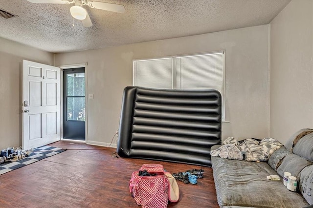 1500 Maple Dr, Midwest City, OK 73110 - entrance foyer with a textured ceiling, a ceiling fan, and wood finished floors