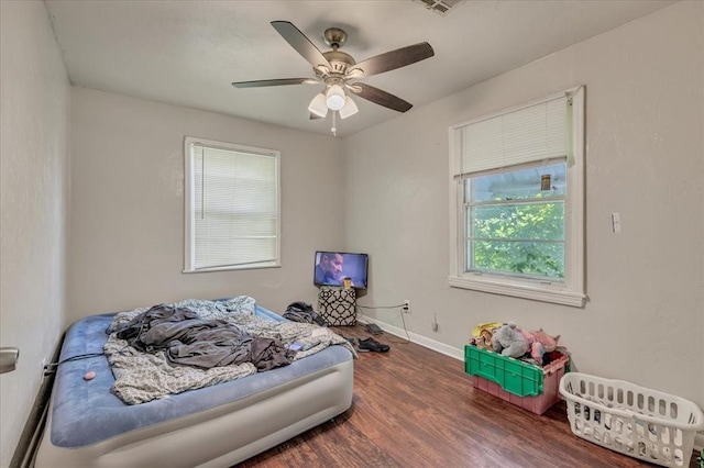 1500 Maple Dr, Midwest City, OK 73110 - bedroom with wood finished floors and ceiling fan