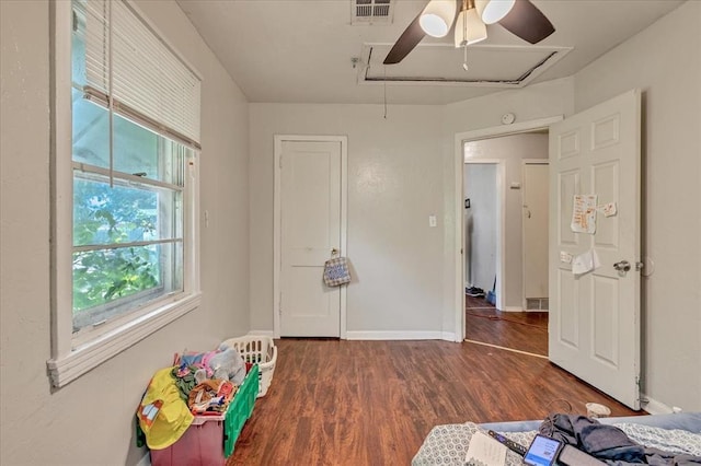 1500 Maple Dr, Midwest City, OK 73110 - unfurnished bedroom featuring attic access, wood finished floors, and ceiling fan
