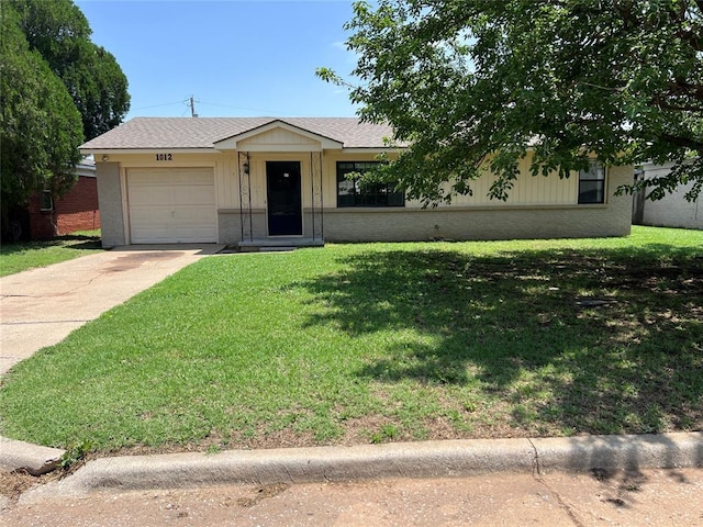 1012 Box St, Altus, OK 73521 - view of front facade featuring brick siding, a garage, driveway, and a front lawn