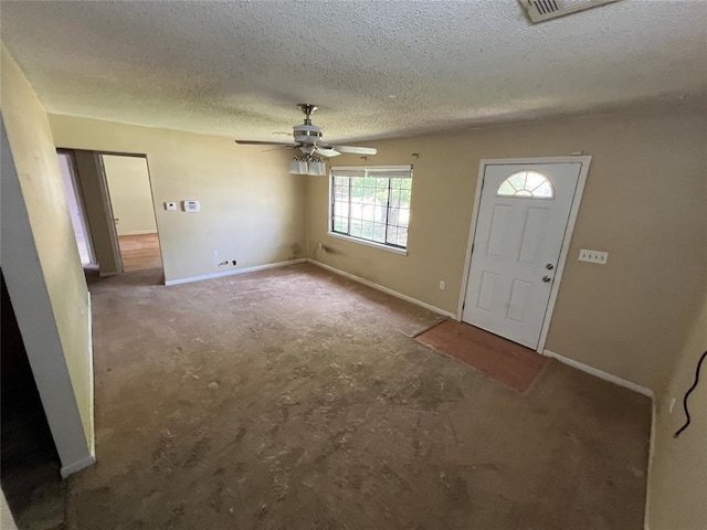 1012 Box St, Altus, OK 73521 - carpeted entryway featuring ceiling fan, baseboards, and a textured ceiling