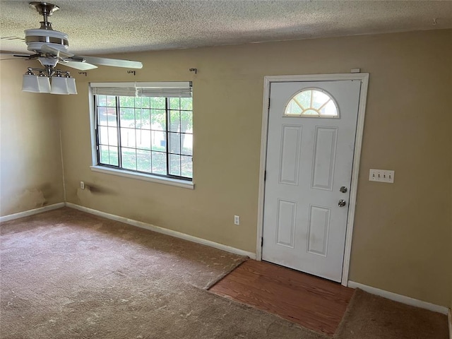 1012 Box St, Altus, OK 73521 - carpeted entryway with a ceiling fan, a textured ceiling, and baseboards