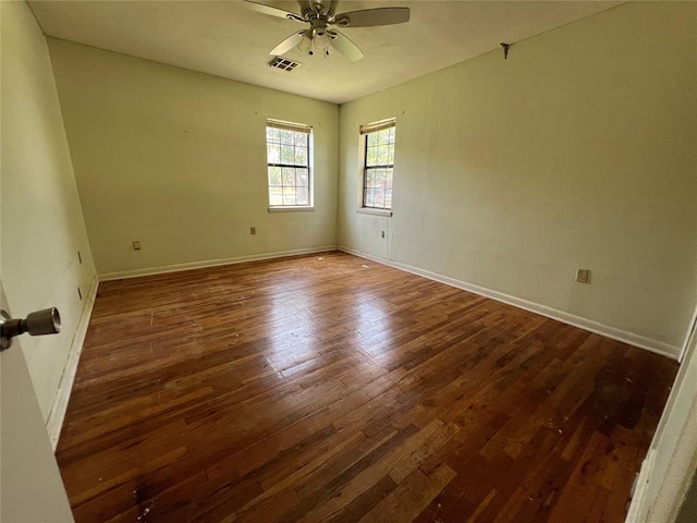 1012 Box St, Altus, OK 73521 - spare room featuring dark wood finished floors, ceiling fan, and baseboards