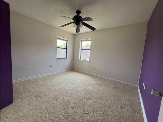 1012 Box St, Altus, OK 73521 - empty room featuring baseboards, carpet flooring, a ceiling fan, and a textured ceiling