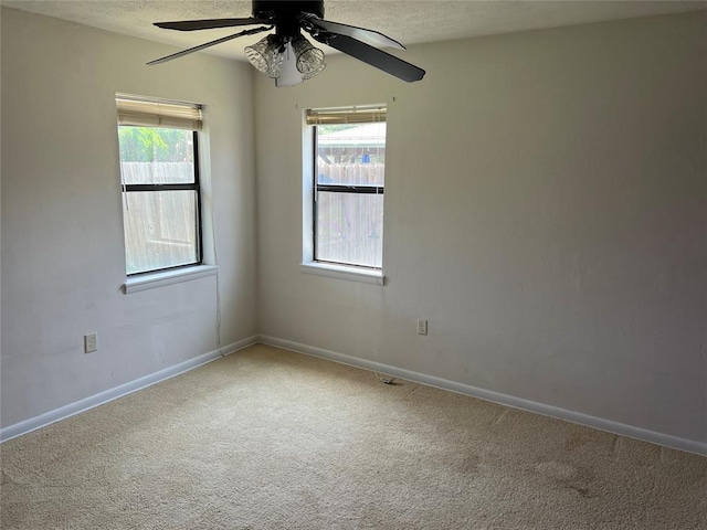 1012 Box St, Altus, OK 73521 - carpeted empty room with ceiling fan, baseboards, healthy amount of natural light, and a textured ceiling