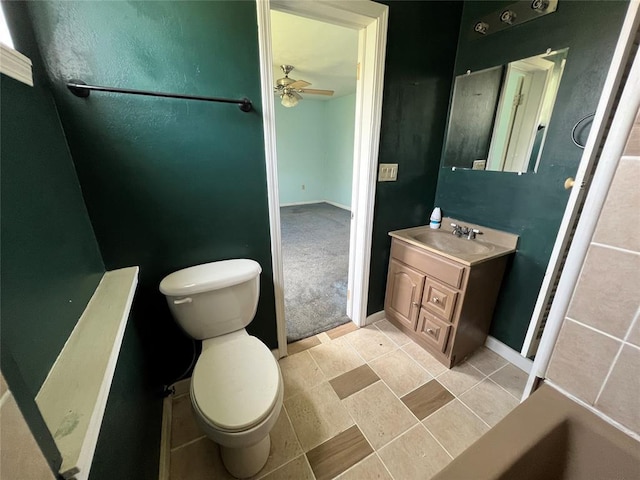 1012 Box St, Altus, OK 73521 - bathroom featuring toilet, vanity, ceiling fan, and baseboards