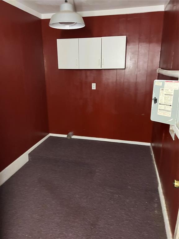 1012 Box St, Altus, OK 73521 - spare room featuring dark carpet and baseboards