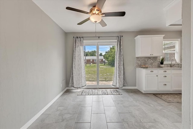 724 SW 48th St, Oklahoma City, OK 73109 - unfurnished dining area with ceiling fan, baseboards, and a sink