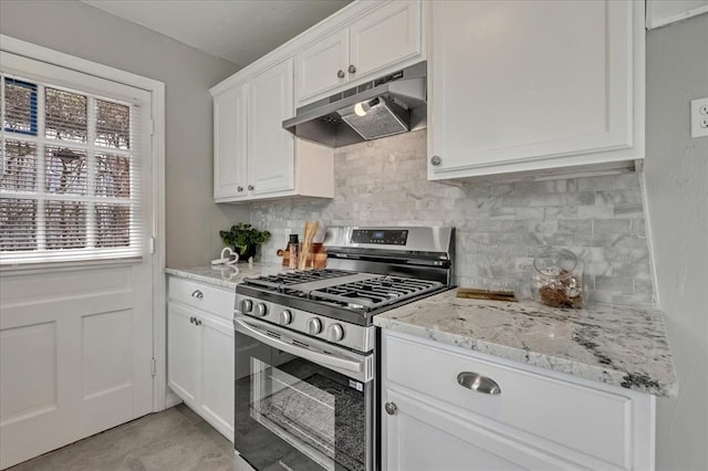 724 SW 48th St, Oklahoma City, OK 73109 - kitchen featuring gas range, under cabinet range hood, tasteful backsplash, white cabinetry, and light stone counters