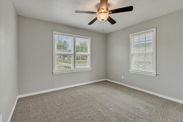 724 SW 48th St, Oklahoma City, OK 73109 - carpeted empty room with plenty of natural light, ceiling fan, and baseboards