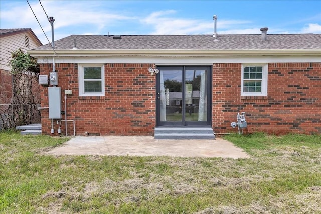 724 SW 48th St, Oklahoma City, OK 73109 - rear view of property featuring brick siding and a yard