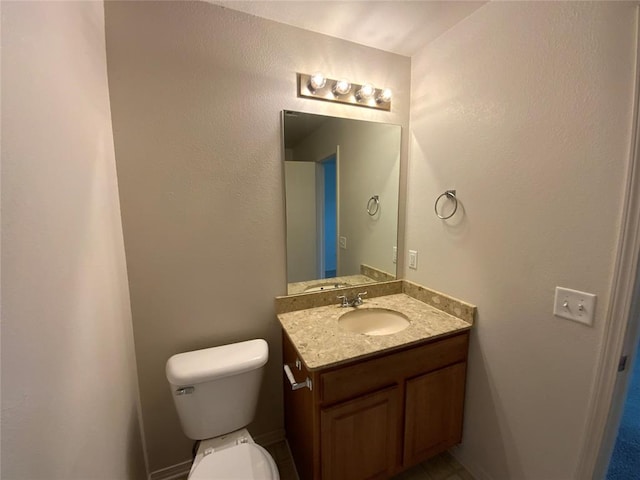 1817 NW 146th St, Edmond, OK 73013 - bathroom featuring toilet, vanity, and baseboards