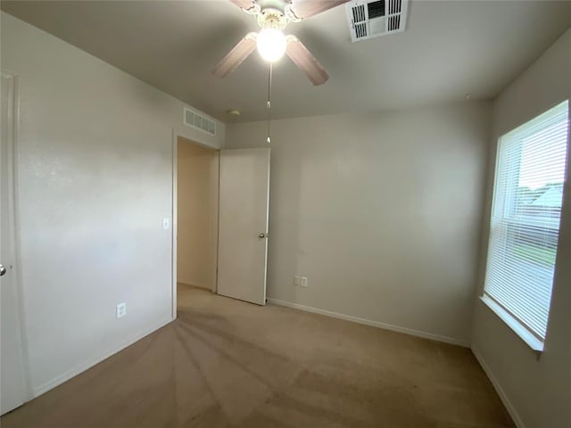1817 NW 146th St, Edmond, OK 73013 - spare room featuring light carpet, a ceiling fan, and baseboards