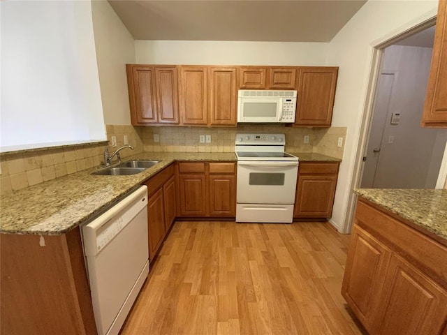 1817 NW 146th St, Edmond, OK 73013 - kitchen featuring white appliances, a sink, light wood finished floors, tasteful backsplash, and light stone counters