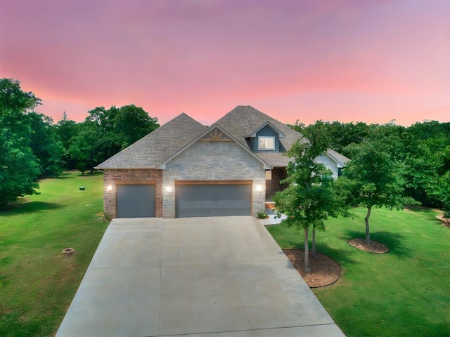 13001 Broken Arrow, Arcadia, OK 73007 - view of front of property with stone siding, a yard, driveway, and a garage