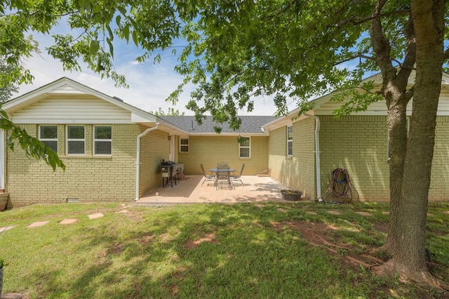 4120 SE 112th St, Moore, OK 73160 - back of property with brick siding, a yard, a patio area, and crawl space