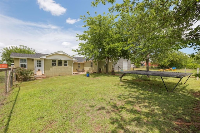 4120 SE 112th St, Moore, OK 73160 - view of yard with a trampoline and asphalt driveway