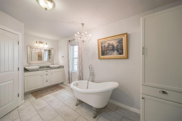 4120 SE 112th St, Moore, OK 73160 - bathroom featuring double vanity, a freestanding bath, a chandelier, tile patterned floors, and baseboards