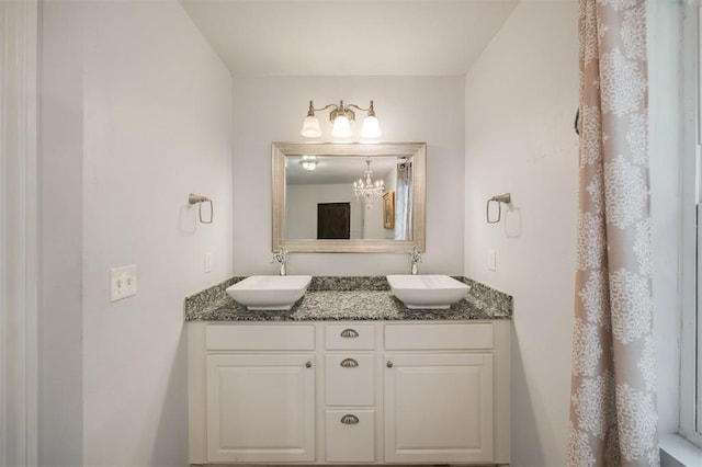 4120 SE 112th St, Moore, OK 73160 - bathroom featuring double vanity and a chandelier