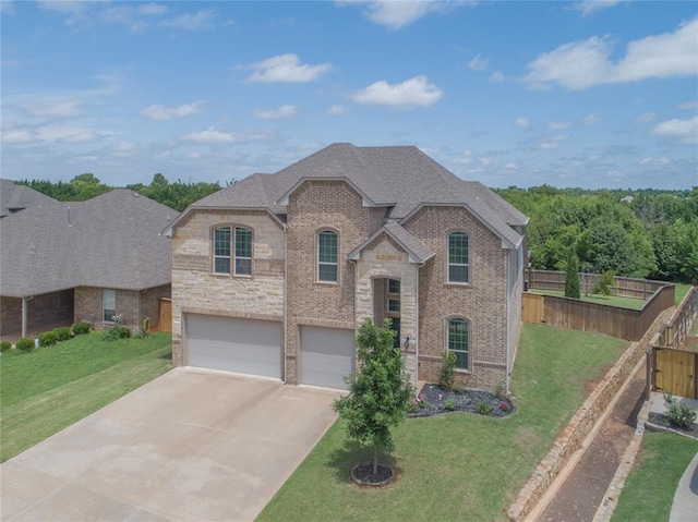 1417 Cordgrass Ct, Edmond, OK 73013 - french provincial home featuring an attached garage, concrete driveway, stone siding, brick siding, and a shingled roof