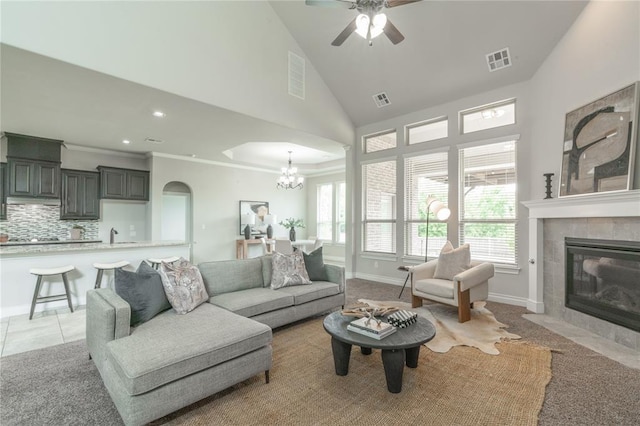 1417 Cordgrass Ct, Edmond, OK 73013 - living area featuring a chandelier, a tile fireplace, ceiling fan, baseboards, and recessed lighting