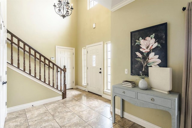 17504 Silverhawk Way, Edmond, OK 73012 - foyer entrance featuring stairs, a chandelier, baseboards, a towering ceiling, and tile patterned flooring