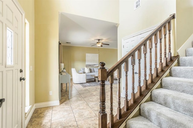 17504 Silverhawk Way, Edmond, OK 73012 - foyer featuring ceiling fan, stairway, light tile patterned floors, and baseboards