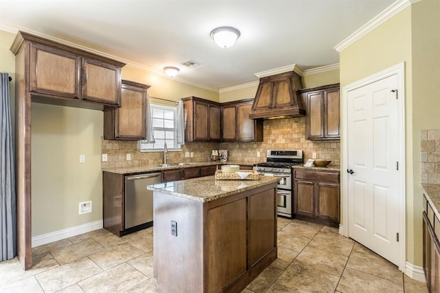 17504 Silverhawk Way, Edmond, OK 73012 - kitchen with stainless steel appliances, tasteful backsplash, light stone countertops, a kitchen island, and crown molding