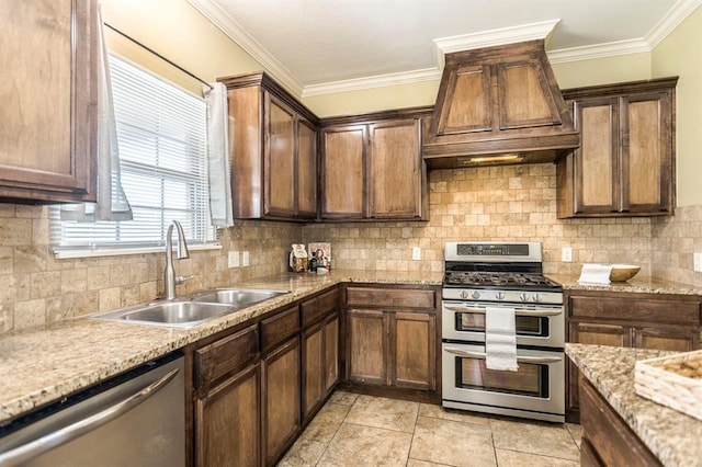 17504 Silverhawk Way, Edmond, OK 73012 - kitchen featuring stainless steel appliances, a sink, crown molding, decorative backsplash, and custom range hood
