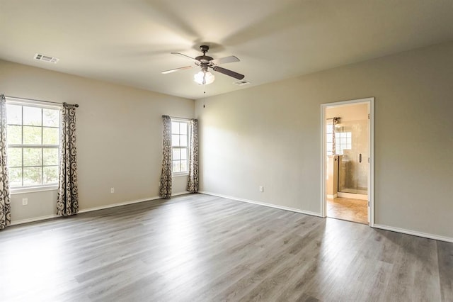 17504 Silverhawk Way, Edmond, OK 73012 - spare room featuring ceiling fan, wood finished floors, and baseboards