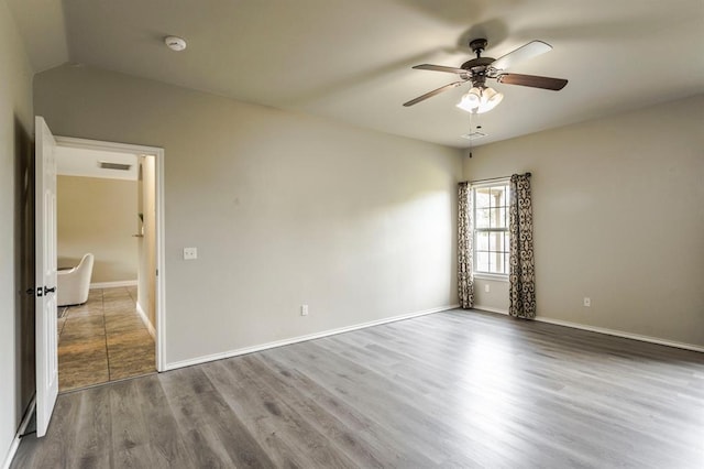 17504 Silverhawk Way, Edmond, OK 73012 - spare room with a ceiling fan, a smoke detector, wood finished floors, and baseboards