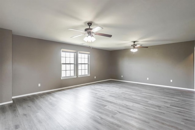 17504 Silverhawk Way, Edmond, OK 73012 - empty room featuring ceiling fan, baseboards, and wood finished floors