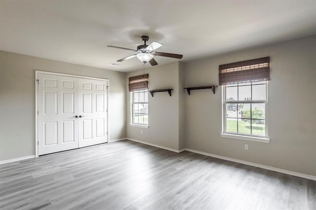 17504 Silverhawk Way, Edmond, OK 73012 - unfurnished bedroom with wood finished floors, baseboards, a closet, and ceiling fan