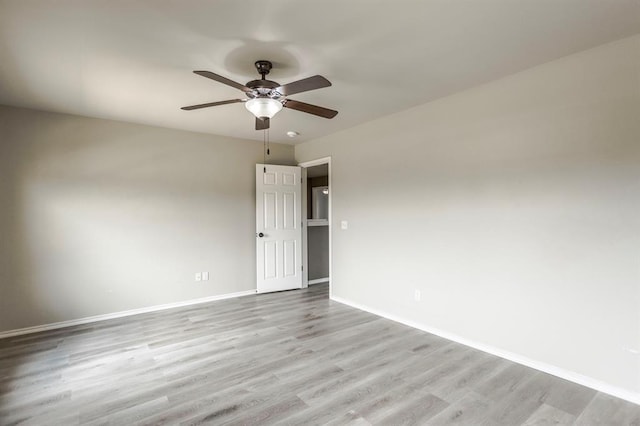 17504 Silverhawk Way, Edmond, OK 73012 - unfurnished room with ceiling fan, wood finished floors, and baseboards