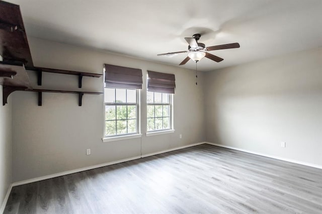 17504 Silverhawk Way, Edmond, OK 73012 - empty room featuring ceiling fan, wood finished floors, and baseboards