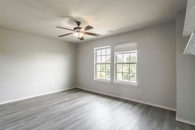 17504 Silverhawk Way, Edmond, OK 73012 - empty room featuring wood finished floors, baseboards, and ceiling fan