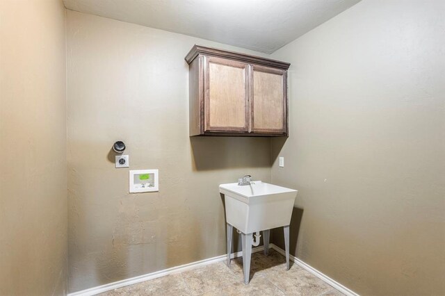 17504 Silverhawk Way, Edmond, OK 73012 - laundry room with electric dryer hookup, hookup for a washing machine, baseboards, and cabinet space