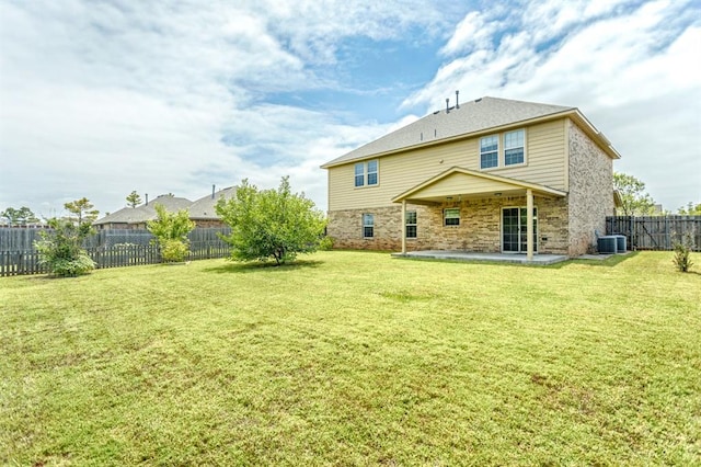 17504 Silverhawk Way, Edmond, OK 73012 - back of house featuring a patio, stone siding, and central air condition unit