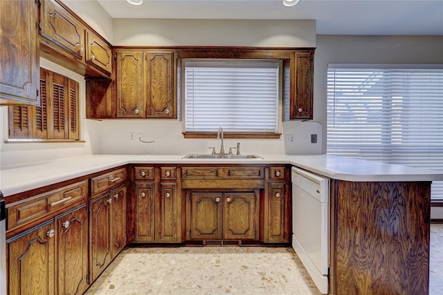 12217 Cork Rd, Oklahoma City, OK 73162 - kitchen with white dishwasher, a peninsula, light countertops, and brown cabinets