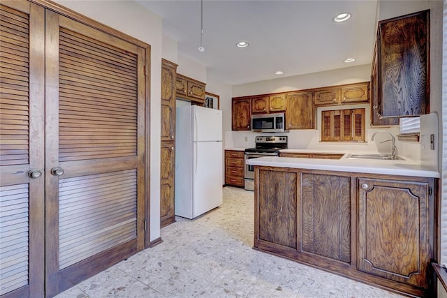 12217 Cork Rd, Oklahoma City, OK 73162 - kitchen featuring appliances with stainless steel finishes, a peninsula, light countertops, and recessed lighting