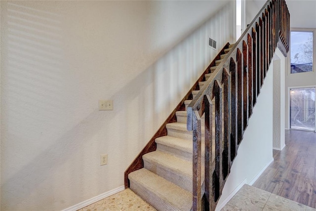 12217 Cork Rd, Oklahoma City, OK 73162 - staircase featuring baseboards and wood finished floors