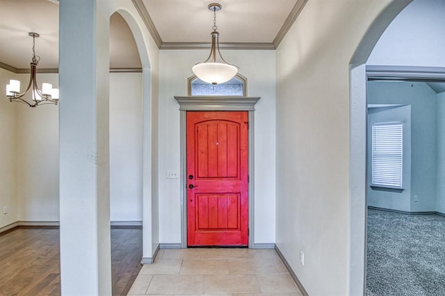 3024 Wakefield Rd, Edmond, OK 73034 - foyer with ornamental molding, a chandelier, and arched walkways