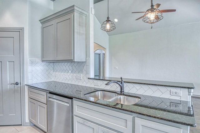3024 Wakefield Rd, Edmond, OK 73034 - kitchen featuring stainless steel dishwasher, decorative backsplash, and dark stone counters