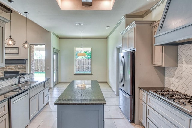 3024 Wakefield Rd, Edmond, OK 73034 - kitchen with stainless steel appliances, a kitchen island, backsplash, healthy amount of natural light, and crown molding